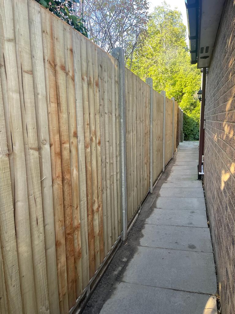 Newly installed wooden fence in alleyway