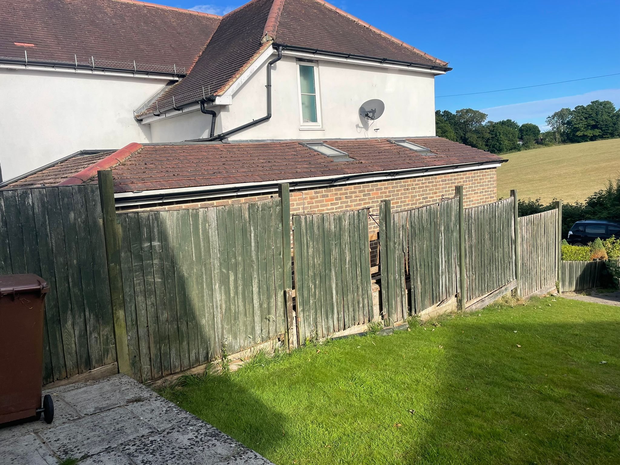 Broken old green wooden fence